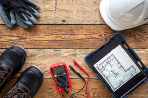 Flat lay composition with electrician's tools and accessories.